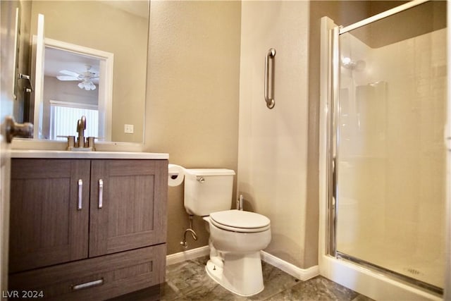 bathroom with vanity, a shower with door, and toilet