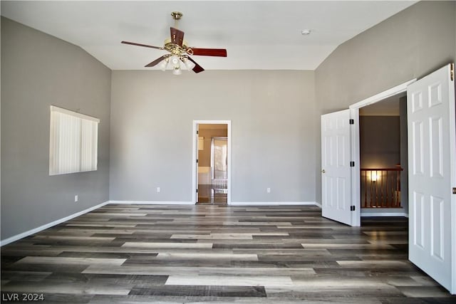 interior space featuring vaulted ceiling, dark wood-type flooring, and ceiling fan