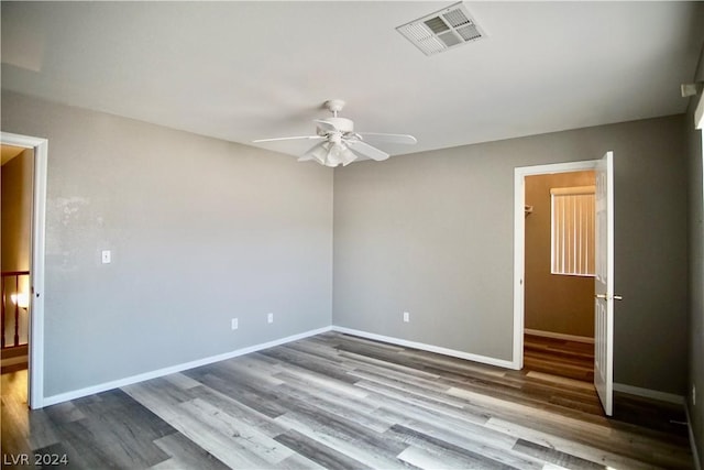 spare room with ceiling fan and wood-type flooring