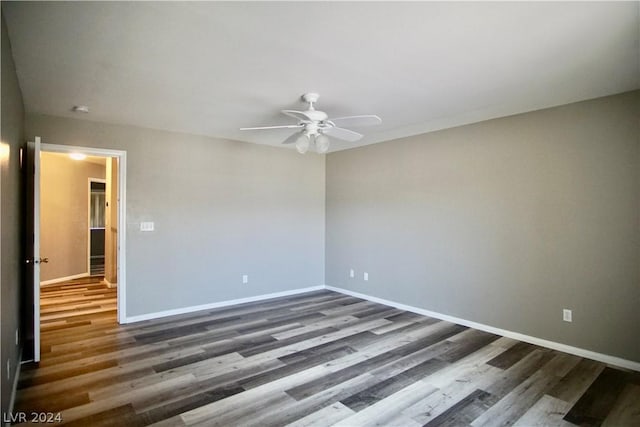 spare room featuring dark hardwood / wood-style floors and ceiling fan