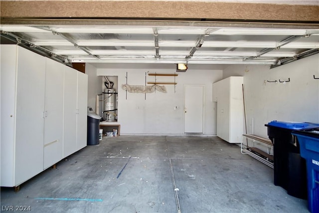 garage with a garage door opener and water heater