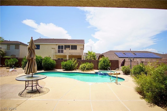 view of swimming pool featuring an in ground hot tub and a patio area