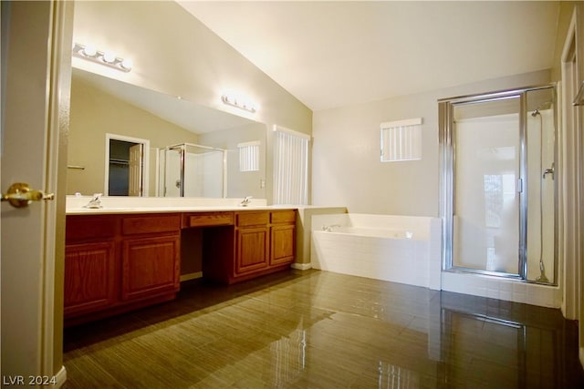 bathroom with vanity, hardwood / wood-style floors, vaulted ceiling, and shower with separate bathtub