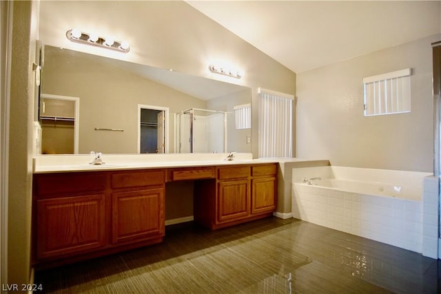 bathroom with vanity, vaulted ceiling, and plus walk in shower