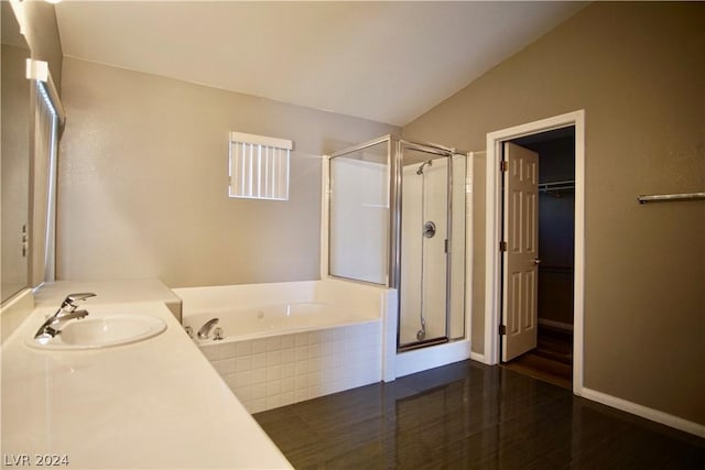 bathroom featuring lofted ceiling, vanity, wood-type flooring, and independent shower and bath