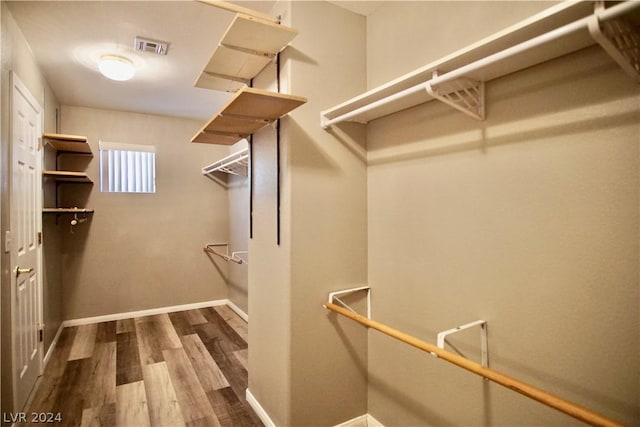 walk in closet featuring dark hardwood / wood-style floors