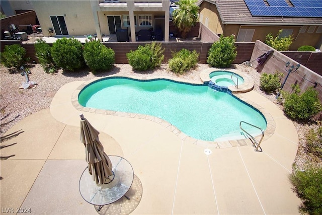 view of swimming pool featuring an in ground hot tub and a patio area