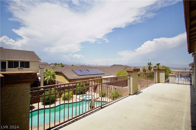 exterior space featuring a swimming pool with hot tub