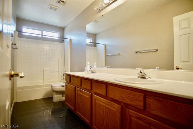 full bathroom featuring vanity, tub / shower combination, and toilet