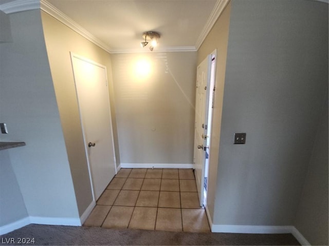 corridor featuring ornamental molding and light tile patterned flooring