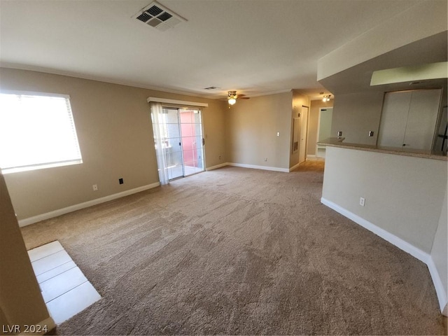 carpeted empty room featuring ornamental molding and ceiling fan