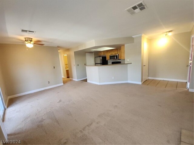 unfurnished living room with light colored carpet and ceiling fan