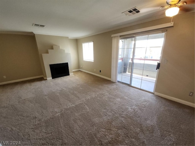 unfurnished living room featuring crown molding and carpet floors