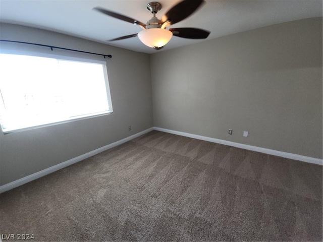 carpeted empty room featuring ceiling fan