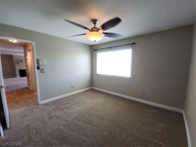 carpeted empty room with ceiling fan