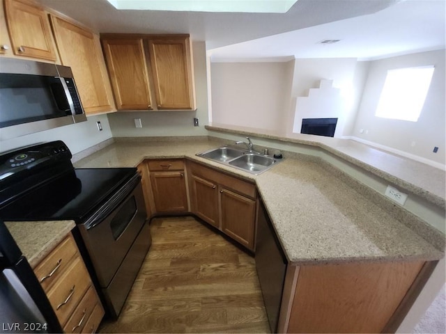 kitchen with electric stove, sink, kitchen peninsula, and dishwasher