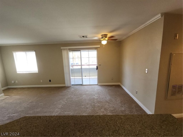 carpeted empty room featuring ornamental molding and ceiling fan