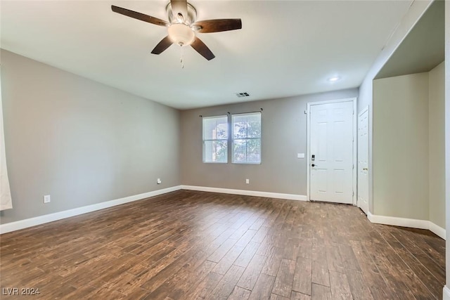 spare room featuring dark wood-type flooring and ceiling fan