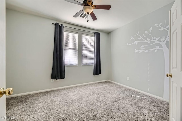 carpeted spare room featuring ceiling fan