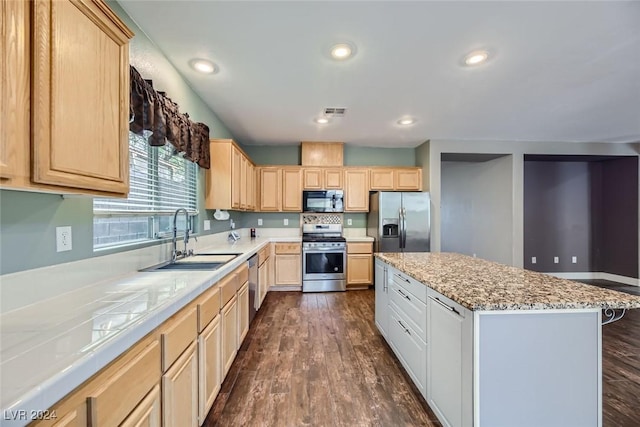 kitchen with dark wood-type flooring, light brown cabinetry, sink, a center island, and appliances with stainless steel finishes