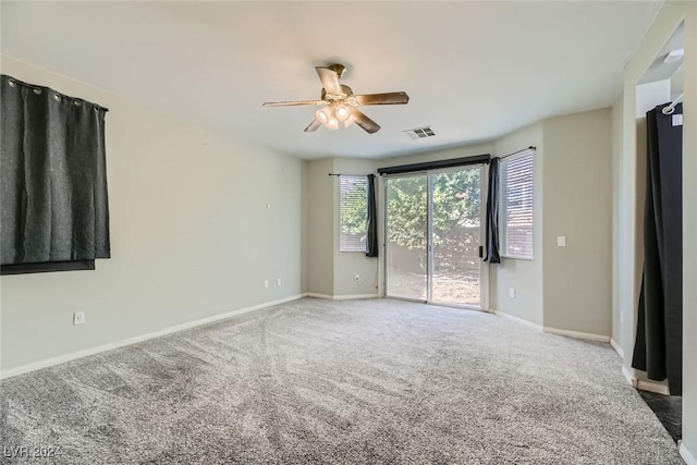 spare room with ceiling fan and carpet