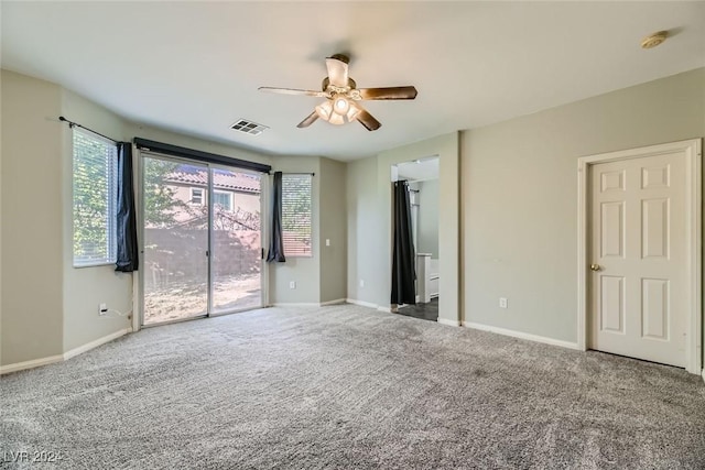 carpeted empty room featuring ceiling fan