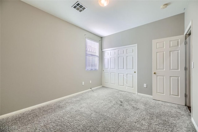 unfurnished bedroom with carpet floors and a closet