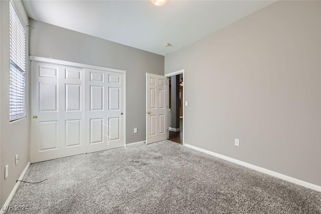 unfurnished bedroom with carpet flooring and a closet