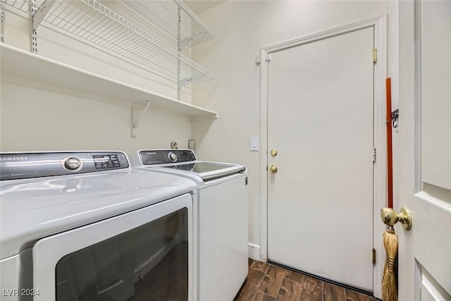 laundry area featuring washer and dryer and dark hardwood / wood-style flooring