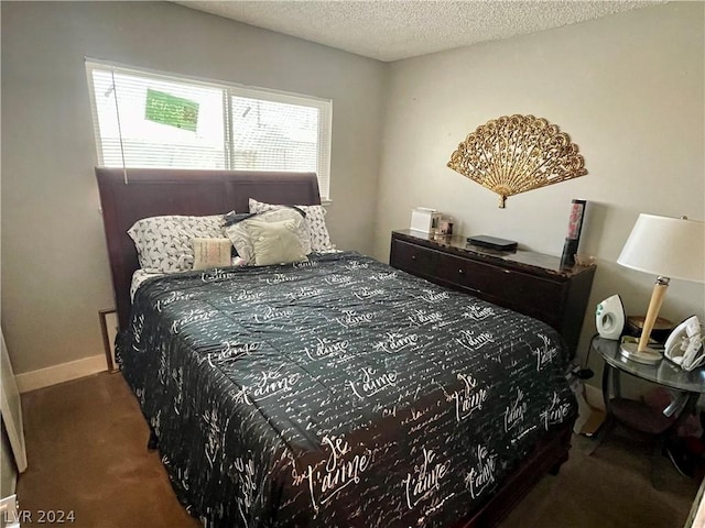 bedroom featuring carpet and a textured ceiling