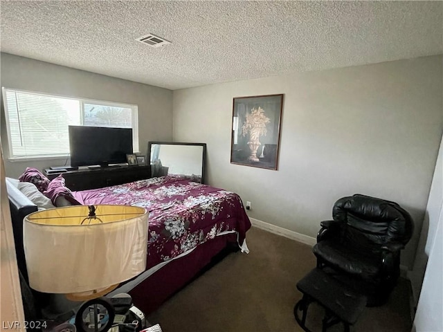 carpeted bedroom with a textured ceiling