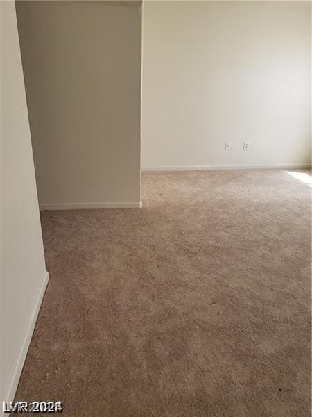 carpeted spare room with baseboards