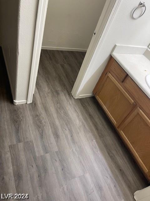 room details featuring baseboards and wood finished floors