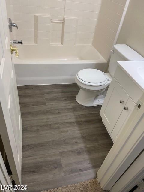 full bath featuring vanity, toilet, wood finished floors, and bathtub / shower combination