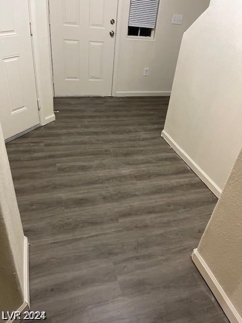 hall with dark wood-type flooring