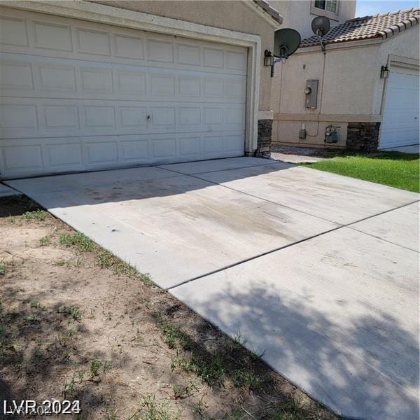 garage with concrete driveway