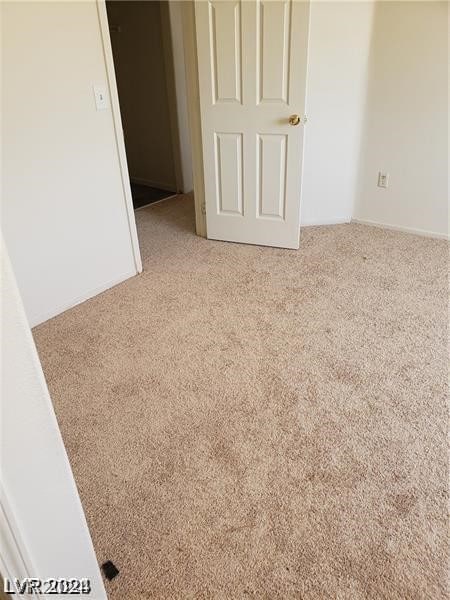 spare room featuring light carpet