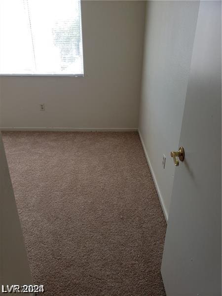 empty room with baseboards and carpet floors