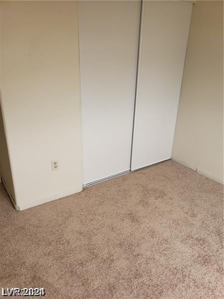 unfurnished bedroom with a closet and carpet flooring