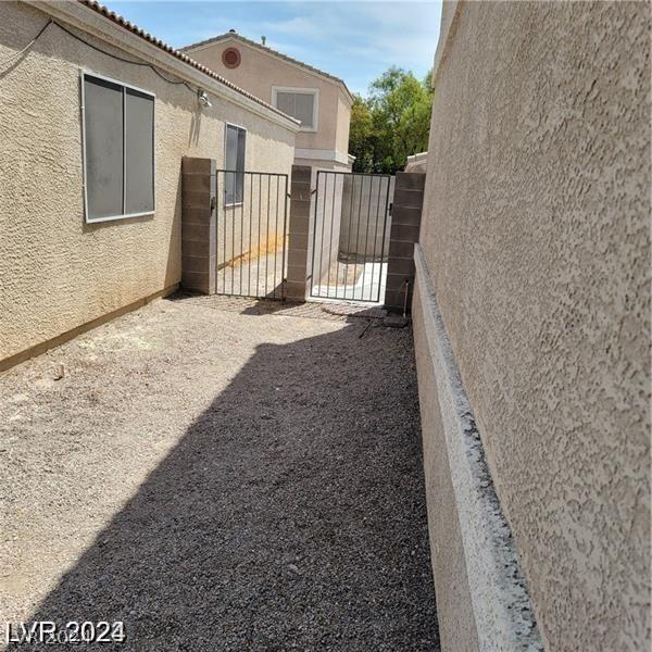 view of yard with fence and a gate