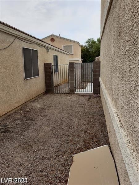 view of yard featuring fence and a gate