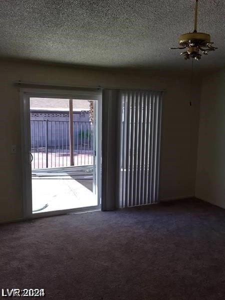 carpeted empty room with a textured ceiling and ceiling fan