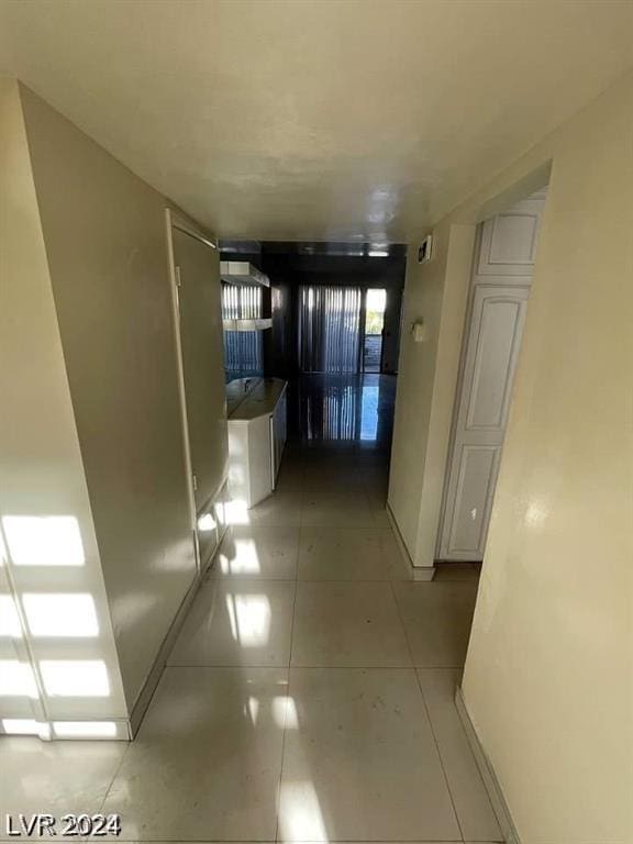 corridor with light tile patterned flooring