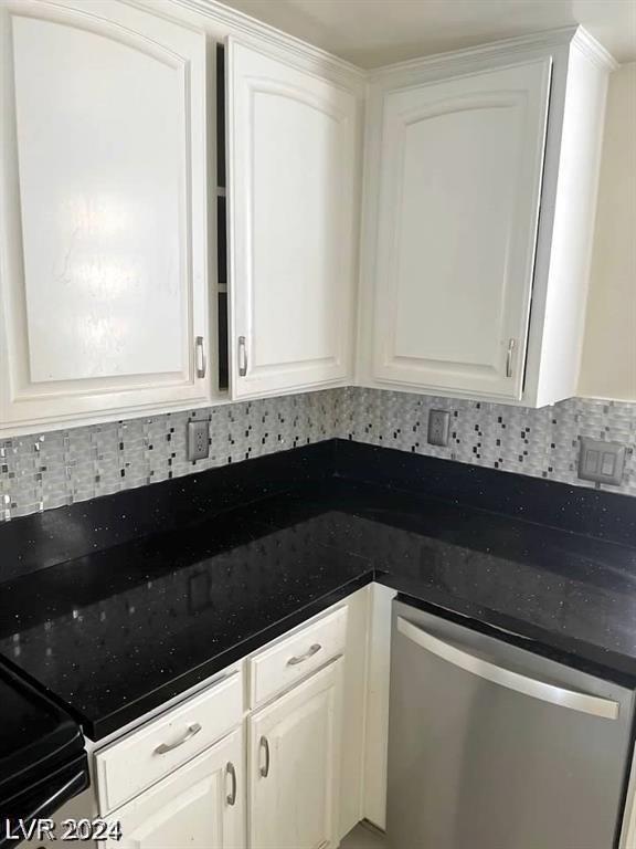 kitchen featuring decorative backsplash, dishwasher, and white cabinets