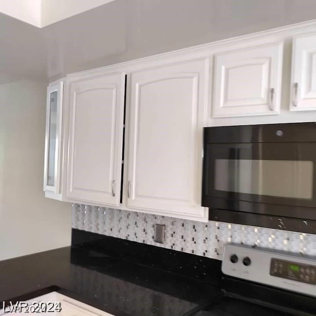 details featuring tasteful backsplash, stainless steel range with electric stovetop, and white cabinets