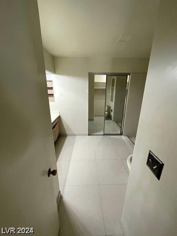 hallway with light tile patterned floors