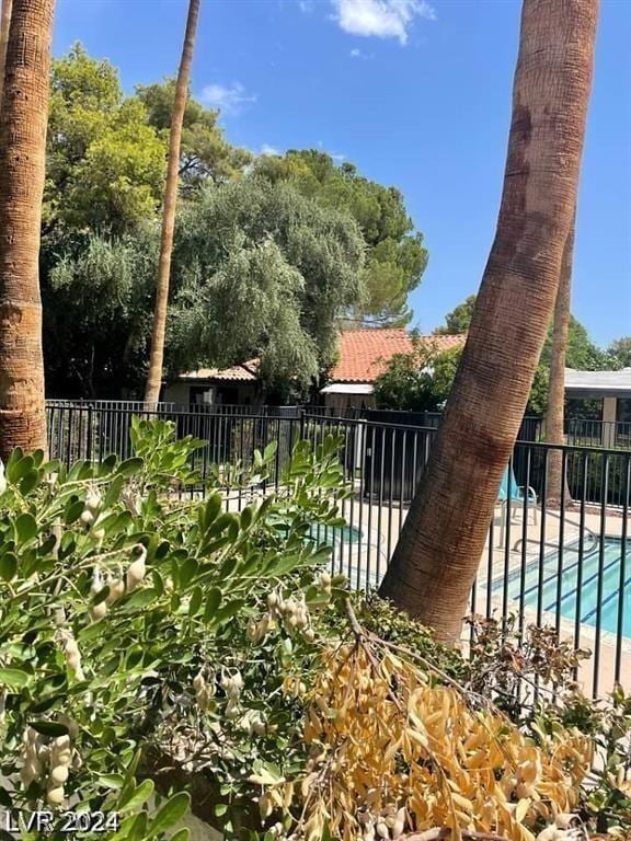 view of yard with a fenced in pool