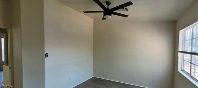 empty room with ceiling fan and dark hardwood / wood-style flooring