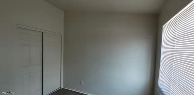 unfurnished bedroom with multiple windows and a closet