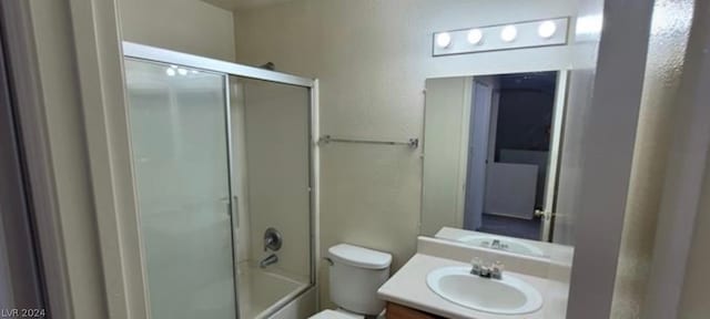 full bathroom with toilet, enclosed tub / shower combo, and vanity